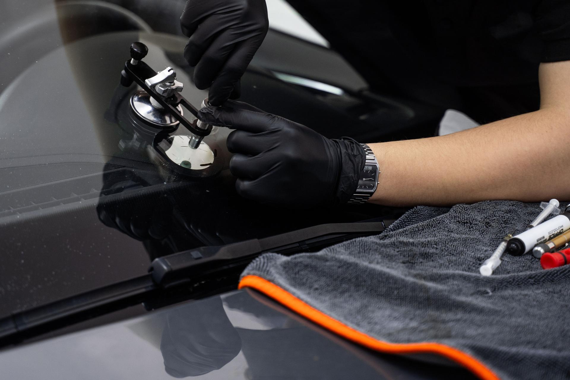 Handheld windshield crack repair for stable resin injection. Repair bridge stabilizes injector while resin is pressed into chip. Suction mount holds steady pressure during curing.